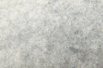 Defocus winter snow blue background. Abstract ice frost natural background with hoarfrost crystals....