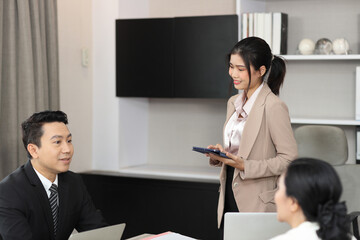Collaborative process of professional businesspeople going over on new project together, using tablet presentation and brainstorming ideas, coworker and working together at office meeting concept
