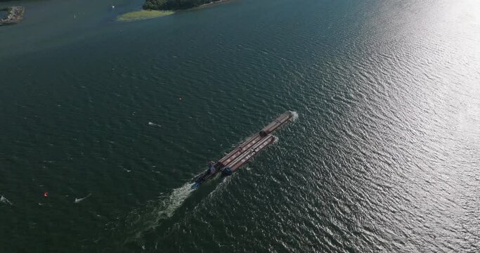 Drone aerial of a barge traveling down the Columbia River Gorge. Shot on Mavic 3 Cine. 30 fps. 4k resolution. Prores.