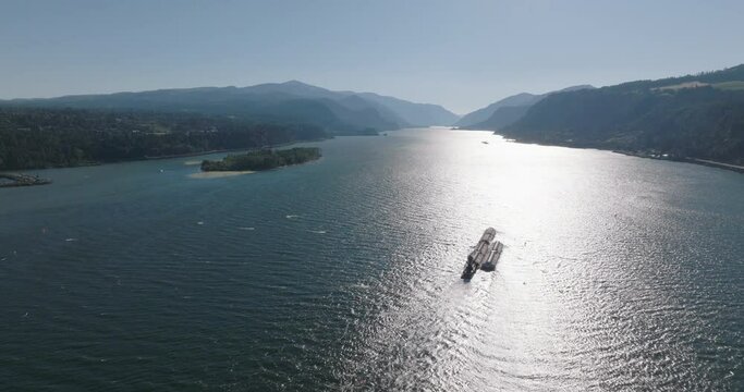 Drone aerial of a barge traveling down the Columbia River Gorge. Shot on Mavic 3 Cine. 30 fps. 4k resolution. Prores.