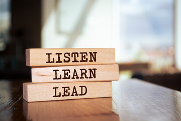 Wooden blocks with words 'Listen, Learn and Lead'.