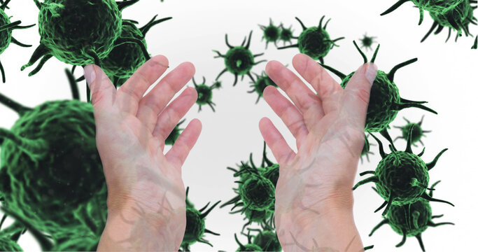 Image of hands of caucasian person held out over green virus cells on white background - Powered by Adobe