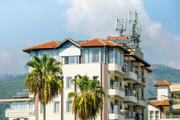 Modern apartment building with balconies on a sunny day in Alanya, Turkey. Rent real estate.