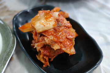 Aged kimchi served on a black plate