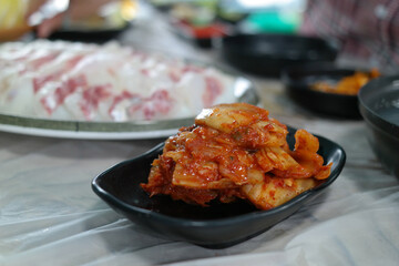 Korean style of eating fresh sashimi and aged kimchi together