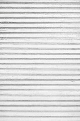 Obraz premium Old desolate corrugated metal roller shutter texture. Grunge metal shutter on store or shop front.