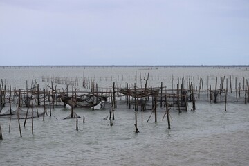 Raising fish in floating islands around Koh Yo Songkhla Lake Fisherman's House at sunset at Songkhla Lake, Yo Island, Thailand