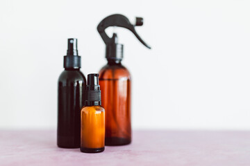 apothecary skincare bottles and scent spray on pink background, organic ingredients in skincare