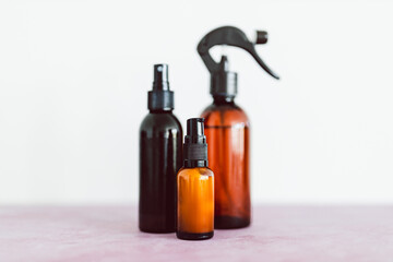 apothecary skincare bottles and scent spray on pink background, organic ingredients in skincare