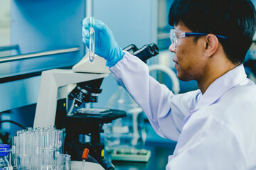 Scientist analyzing medical sample in laboratory

