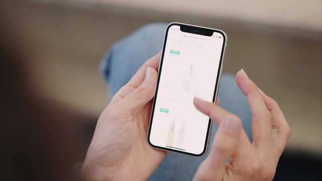 Lipstick shopping, phone website and woman on the internet for makeup sale with smartphone in living room of house. Hands and screen of cellphone with person on a mobile app for cosmetics in home