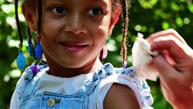 grandma caring african tender baby girl bited by mosquito outdoors