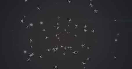 Image of diverse grey stars falling over black background
