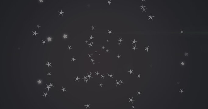 Image of diverse grey stars falling over black background