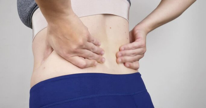 woman with back pain, hernia in the lower back. High quality 4k footage