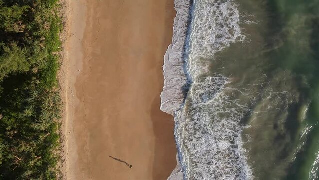 top view shot drone follow runer running on beach