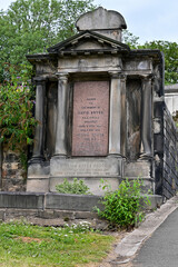 Old headstone with pillars in New Calton Burial Ground Cemetery, Edinburgh, Scotland