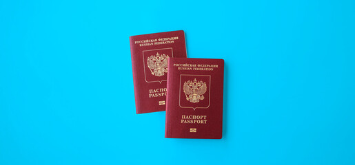 Two Russian international passports on a blue background. The concept of a vacation for two abroad.