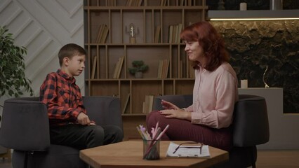 Autism therapist playing games with autistic kid. School boy with autism studying with psychologist. Autistic child learns to focus attention and coordination. - Powered by Adobe