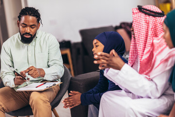 Real estate agent  discussing with a arab family who signs a contract for the purchase of an apartment.