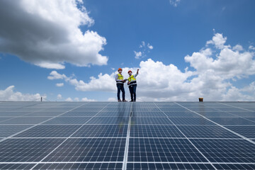 Engineers walking on roof inspect and check solar cell panel by hold equipment box and radio communication ,solar cell is smart grid ecology energy sunlight alternative power factory concept © APchanel