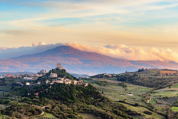 View over Castiglione d'Orcia in evening light in the Val d'Orcia in Tuscany, Italy, with Monte...