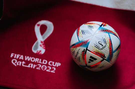 QATAR, DOHA, 18 JULY, 2022: Official World Cup Football Ball Al Rihla. And logo of FIFA World Cup in Qatar 2022 on red carpet. Soccer sport background, edit space. Qatar 22 Wallpaper.