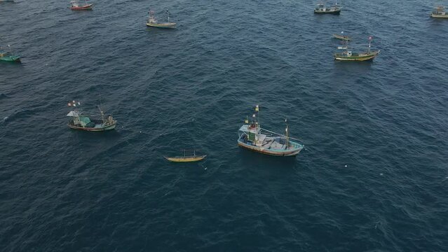 Aerial Drone Shot of Anchored Fishing Boats Out at Sea