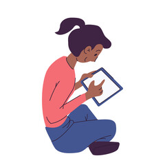 African American woman using a tablet sitting on the ground. Resting in the open air