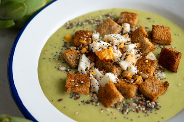Artichoke cream with bread croutons and boiled egg. Typical Spanish vegan tapas.