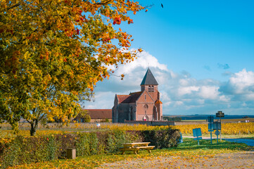 Burgundy, vineyards and landscape in autumn. Church and blue sky