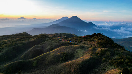 Aerial view of beauty mountain peaks Prau Dieng, Central Java and the climbers and tent. 