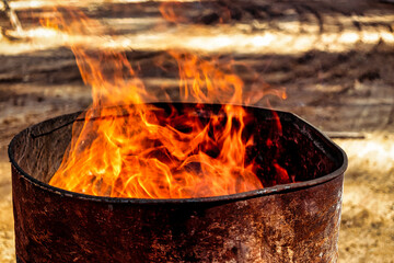 Burning fire in a barrel close-up. Bright flame. Open flame heating. Problems with heating and gas.