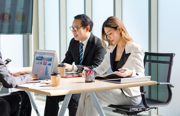 Millennial Asian successful professional male businessmen and female businesswomen audiences in formal suit sitting meeting together in company conference office room.