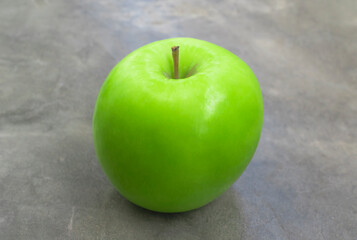 Healthy fruit green apple on stone table close up.