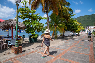 woman walking on beautiful little street front of tropical beach of Martinique