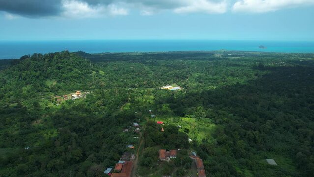 Aerial view over the Roça Agostinho Neto town and jungle, towards the coastline in Sao Tome, Africa