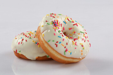 Traditional American donuts. flying over white background.Traditional American donuts. flying over white background.