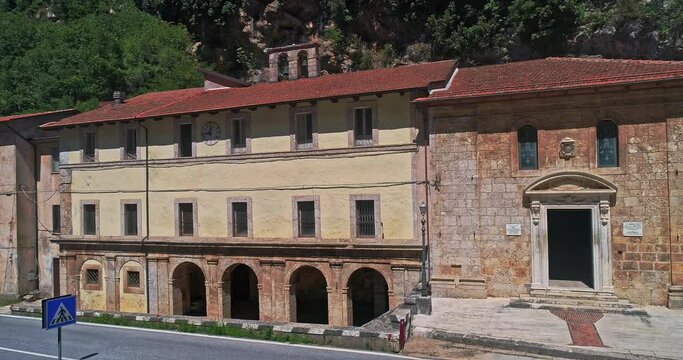 Aerial view with movement towards the facade of the Sanctuary of the Madonna delle Grotte in Antrodoco in the province of Rieti. Lazio, Italy, Europe