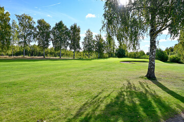 Fototapeta na wymiar backlight over green and fairway on Kumla golf course