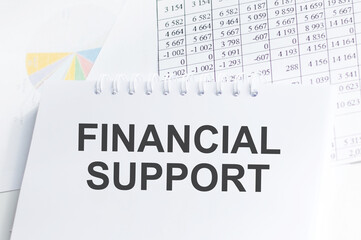 a notebook with the inscription FINANCIAL SUPPORT