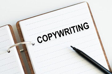 Business concept. Text Copywriting on a notepad on a bright table