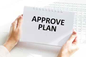 a man writes the text approve plan