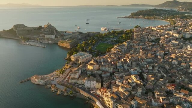 Flying over old town of Kerkyra, Corfu island, Greece. Old Fortress of Corfu, lagoons with yachts and old town in Kerkyra, in the soft morning sun. The beauty of the Greek island of Corfu