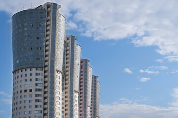 Fototapeta na wymiar High buildings in the city, skyscraper against blue sky