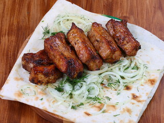 Shish kebab on ribs with onions on pita bread
