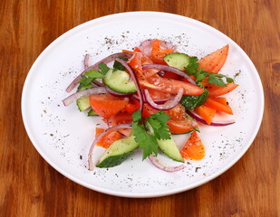 cucumber tomato salad on white plate