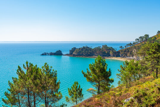 View of the famous "Ile vierge" (Virgin island) on the GR34 hiking track between Cap de la chevre (Cape of the goat) and Morgat, Brittany, France. Atlantic ocean with blue sky on the background.