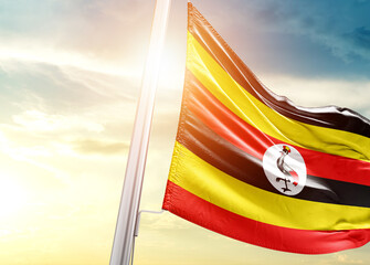 Uganda national flag cloth fabric waving on the sky - Image