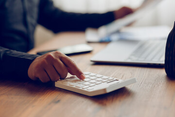 man doing financial advisor accounting Work with calculators and laptops